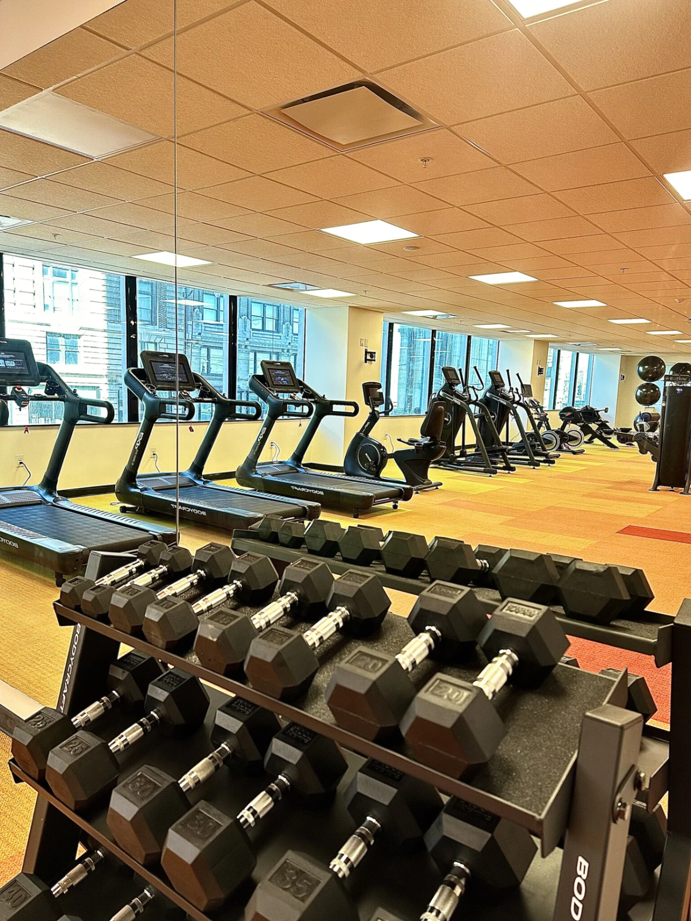 24-hour fitness center with treadmills, ellipticals, and free weights