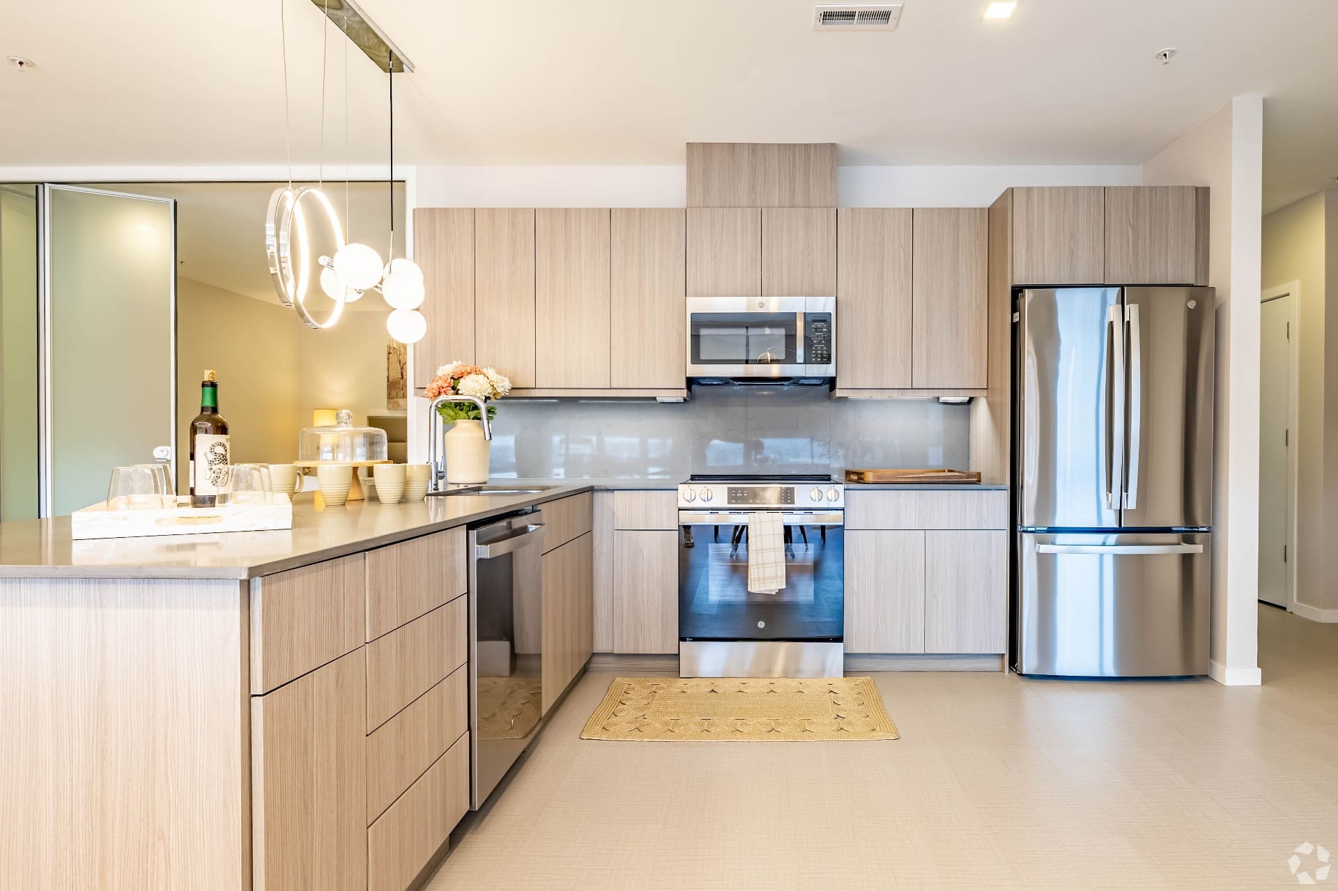 Modern kitchen with light wood cabinets and stainless steel appliances